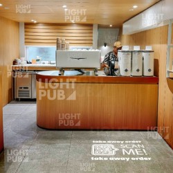 Illuminated QR code on floor for phygital in restaurant